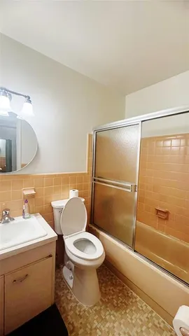 a bathroom with a toilet a sink and a shower