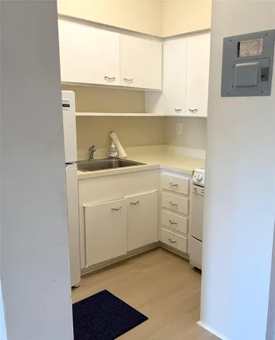 a kitchen with a sink cabinets and appliances