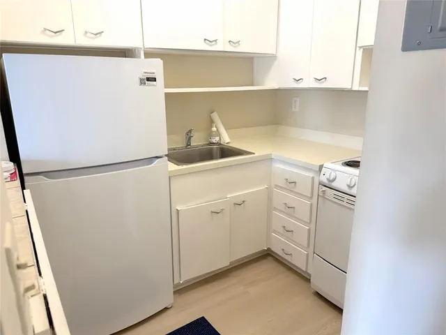 a utility room with cabinets washer and dryer