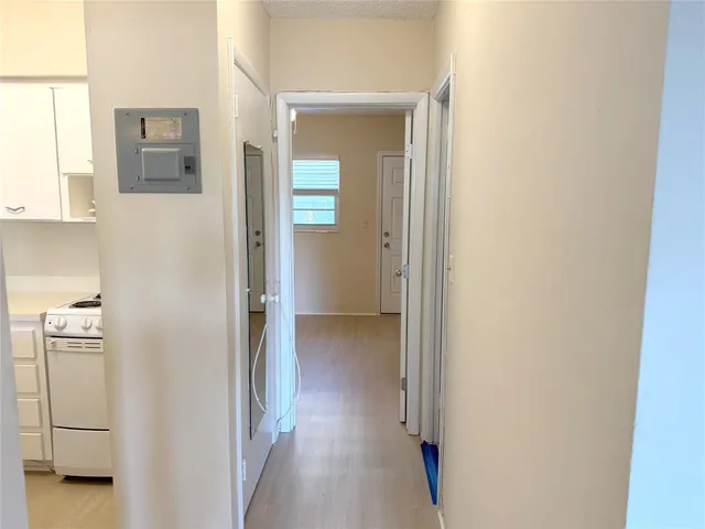 a view of a hallway with closet and a livingroom