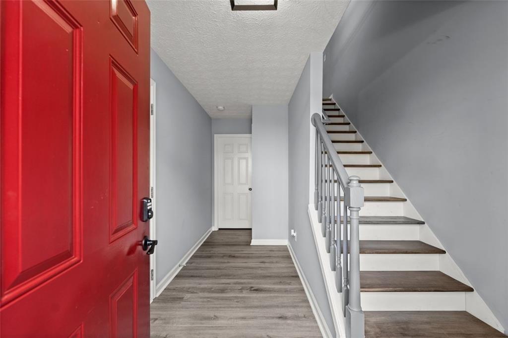 4711 Poplar Ridge Court Oakwood, GA 30566 - Photo 2 of 15 a view of a hallway with wooden floor and entryway