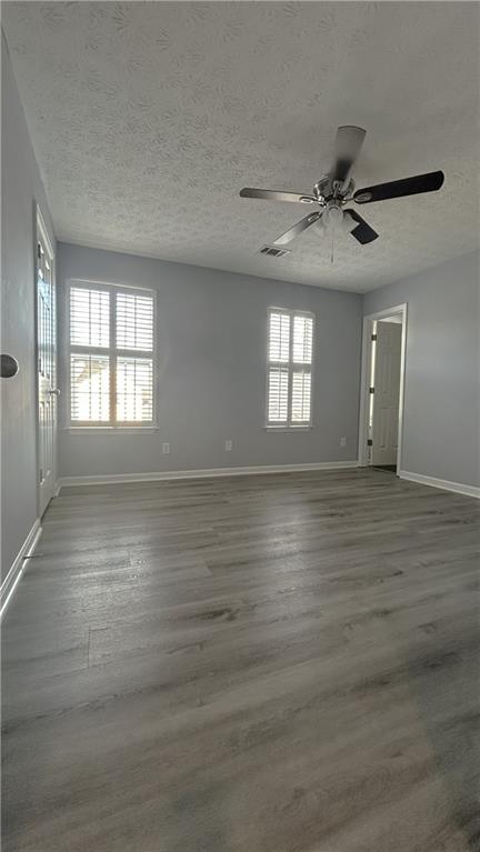 4711 Poplar Ridge Court Oakwood, GA 30566 - Photo 8 of 15 a view of an empty room with window and wooden floor