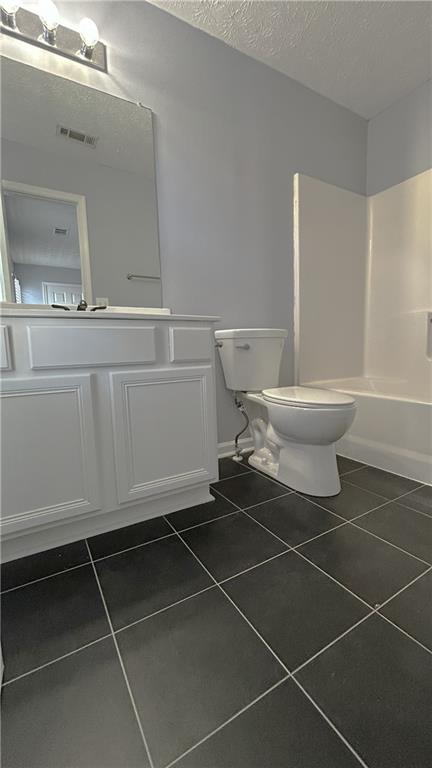 4711 Poplar Ridge Court Oakwood, GA 30566 - Photo 9 of 15 a bathroom with a toilet and a mirror