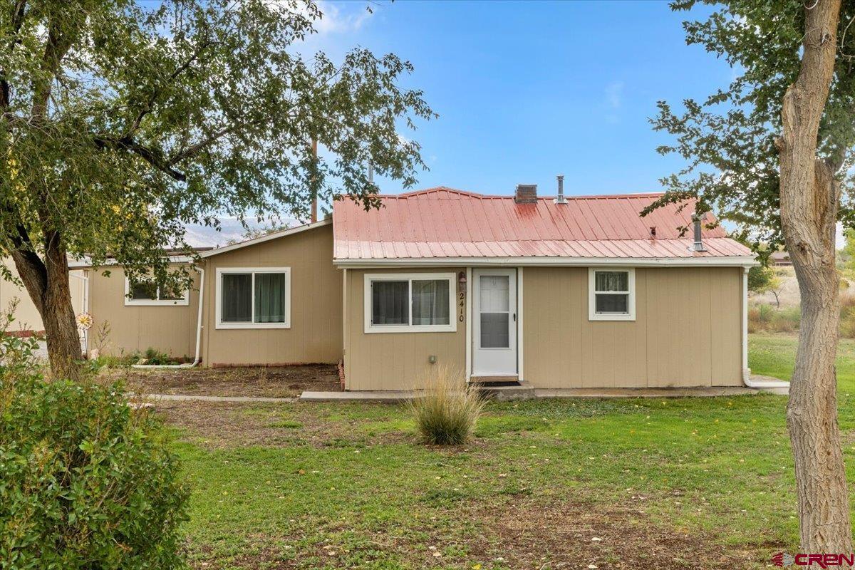 2410 6450th Road Montrose, CO 81401 - Photo 12 of 23 a view of a house with a yard