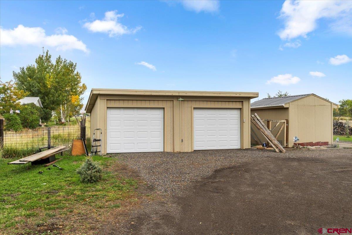 2410 6450th Road Montrose, CO 81401 - Photo 15 of 23 a view of house with backyard and bushes