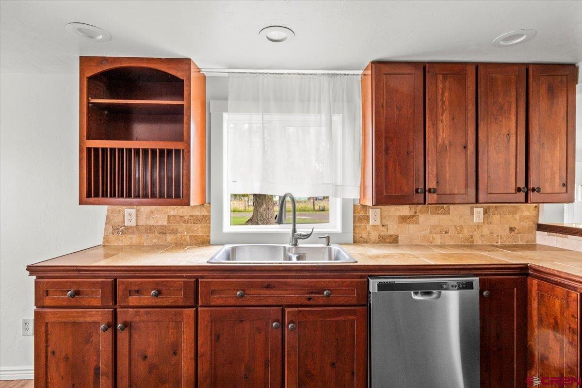 2410 6450th Road Montrose, CO 81401 - Photo 17 of 23 a kitchen with a sink and a window