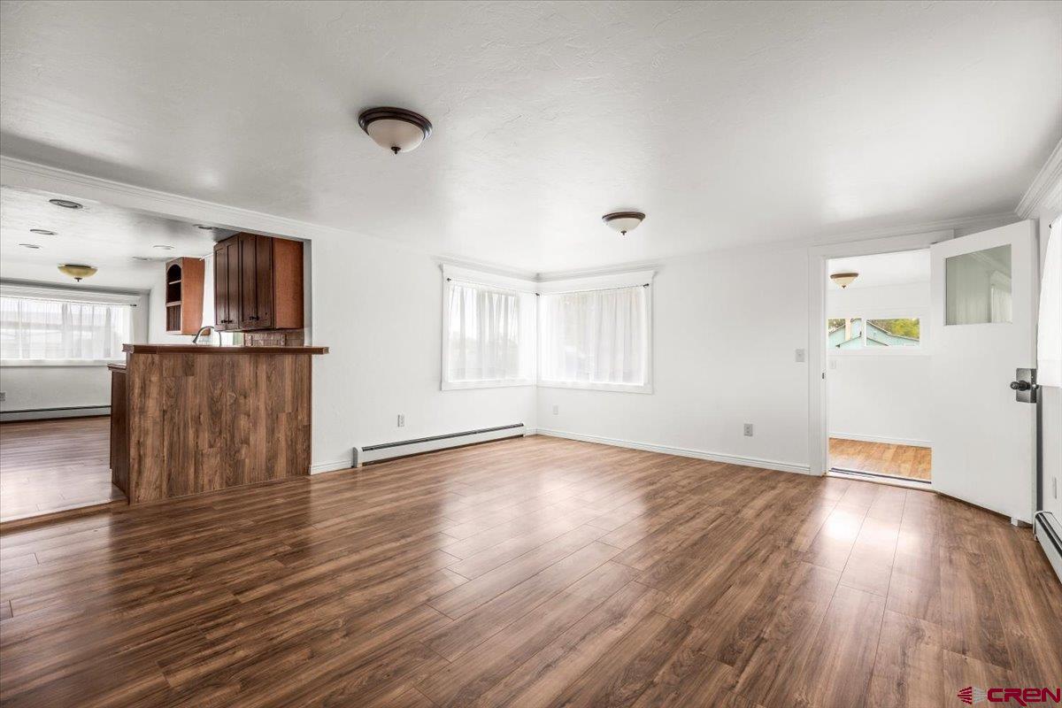 2410 6450th Road Montrose, CO 81401 - Photo 21 of 23 a view of a livingroom with wooden floor and window