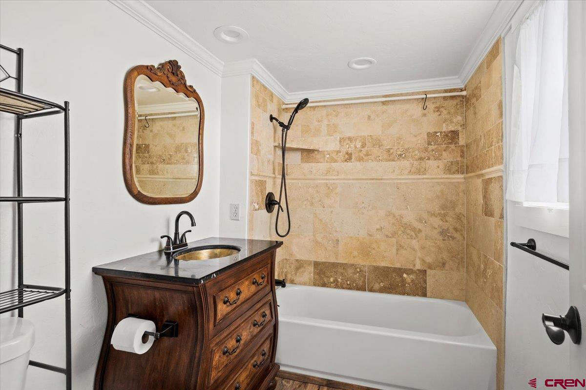 2410 6450th Road Montrose, CO 81401 - Photo 3 of 23 a bathroom with a tub sink and mirror