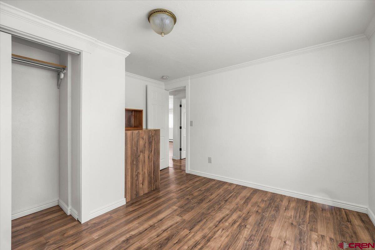 2410 6450th Road Montrose, CO 81401 - Photo 9 of 23 wooden floor in an empty room