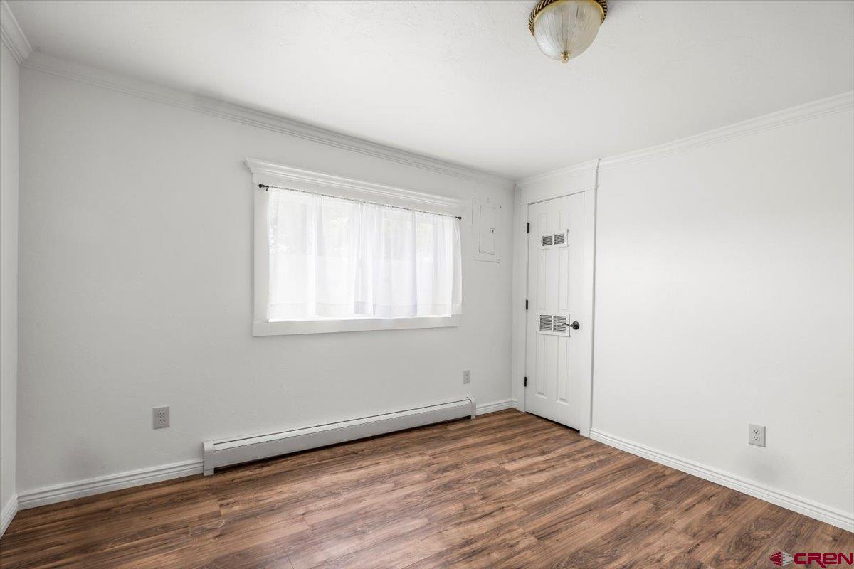 2410 6450th Road Montrose, CO 81401 - Photo 10 of 23 a view of a livingroom with wooden floor and window