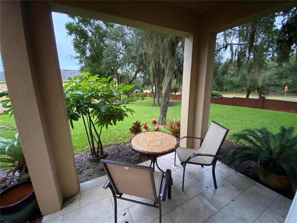 1772 Marsh Palm Parkway Ocoee, FL 34761 - Photo 14 of 29 a view of a porch with furniture and a yard