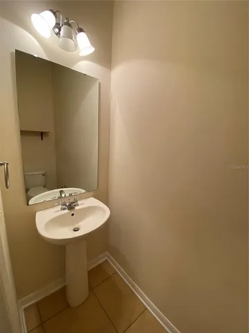 a bathroom with a sink and mirror