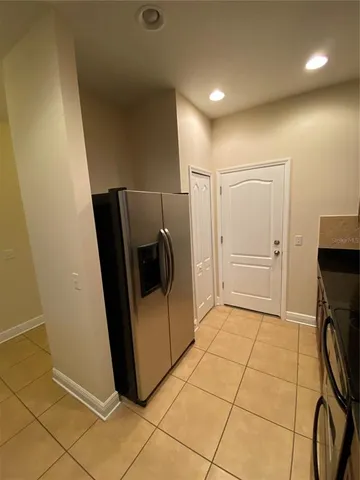a kitchen with stainless steel appliances granite countertop a refrigerator and a stove