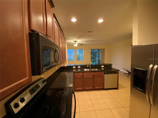 a kitchen with granite countertop a stove and a sink