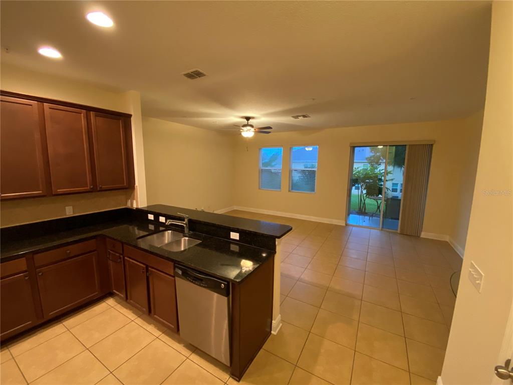 1772 Marsh Palm Parkway Ocoee, FL 34761 - Photo 10 of 29 a kitchen with granite countertop a stove and a sink