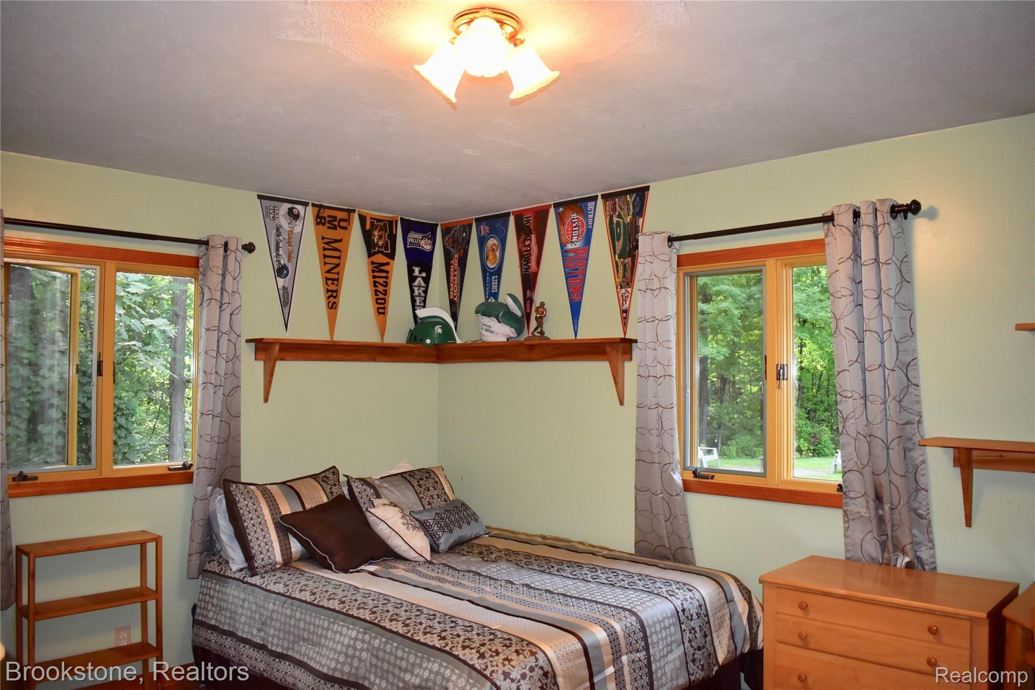 405 Baldwin Ridge Oxford, MI 48371 - Photo 37 of 54 THE 3 BEDROOMS AT THE SOUTHEAST END OF THE HOUSE WERE THE CHILDREN'S BEDROOMS. THIS LARGE BEDROOM (11X14) FEATURES 2 WINDOWS, A WOOD FLOOR & A LARGE CLOSET