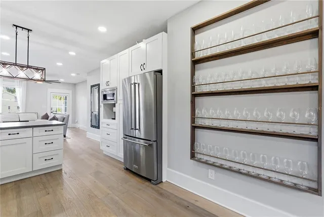 a kitchen with stainless steel appliances a refrigerator and a stove top oven