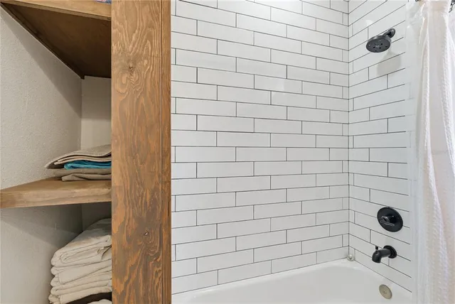 a bathroom with a bathtub and shower