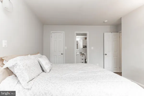 a large white bed in a white room