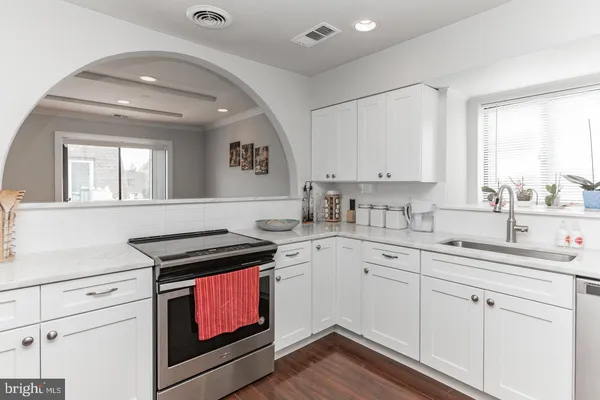 a kitchen with a sink stove and cabinets