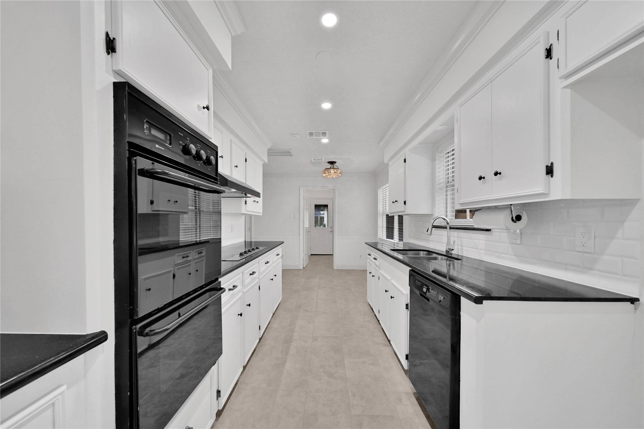 9411 Roos Road Houston, TX 77036 - Photo 16 of 41 a kitchen with stainless steel appliances sink a stove and cabinets