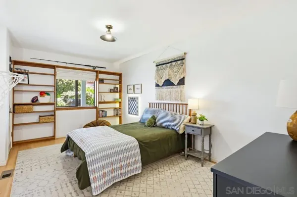 a bedroom with a bed and a large window with garden view