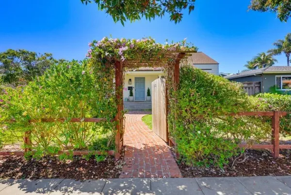 a front view of a house with a garden