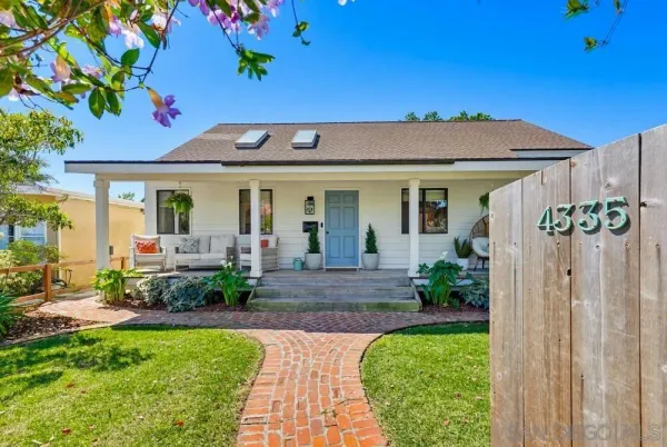 a front view of a house with a yard and porch