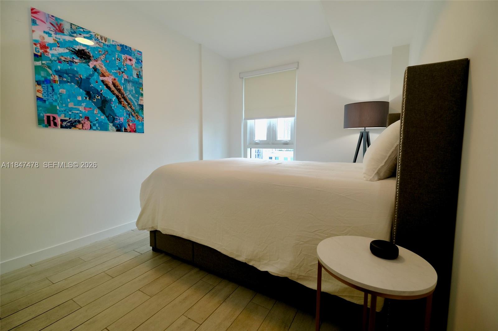 321 Northeast 26th Street, Unit 709 Miami, FL 33137 - Photo 6 of 13 a room with a bed and wall paintings