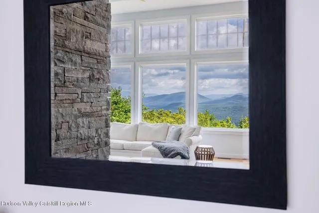 a dining room with furniture a chandelier and wooden floor