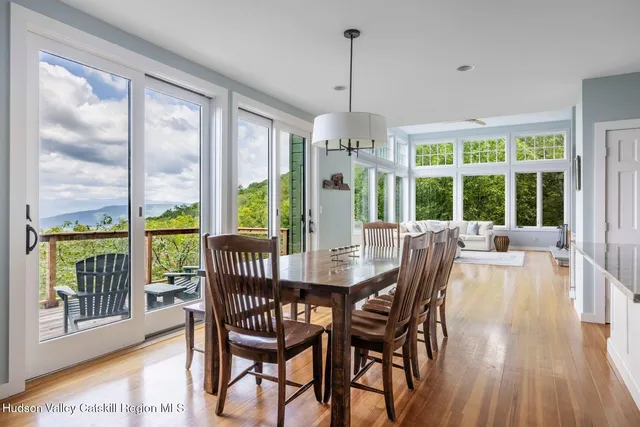 a living room with furniture and floor to ceiling windows