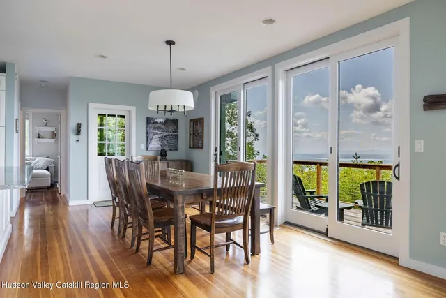 a kitchen with kitchen island granite countertop a sink cabinets a window and stainless steel appliances