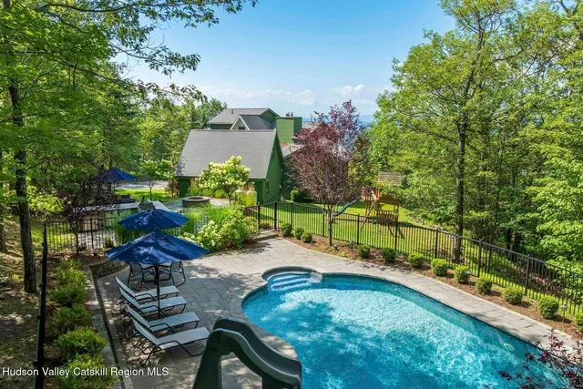 a front view of a house with a tree