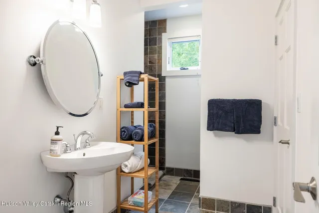 a bedroom with a bed and a large window with outer view