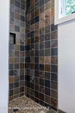 an empty room with windows and ceiling fan