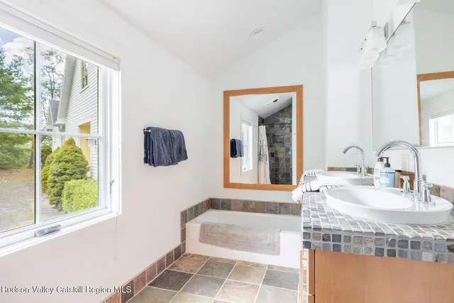 a view of a patio with table and chairs potted plants and large tree