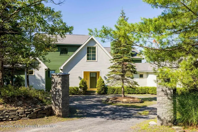 a hallway with a wooden floor and a potted plant on a table