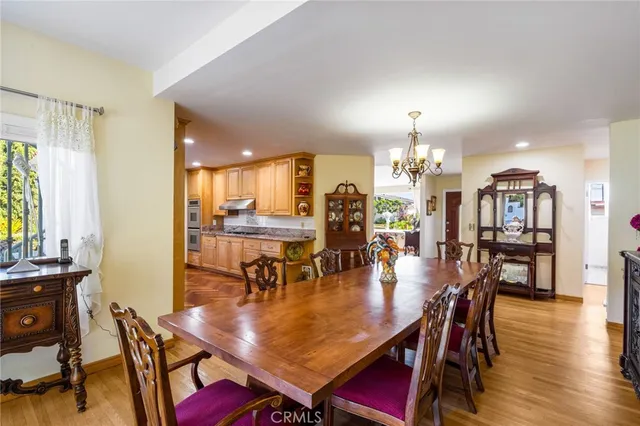 a large kitchen with stainless steel appliances granite countertop a stove a sink and a microwave