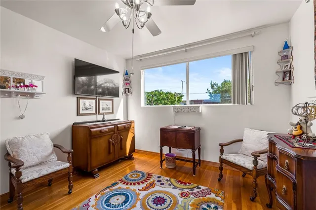 a bedroom with furniture and a large window