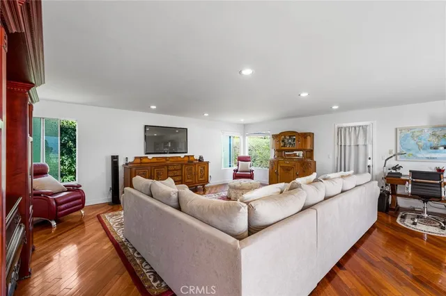 a view of a patio with table and chairs potted plants and large tree