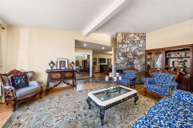 a living room with furniture a chandelier and a dining table