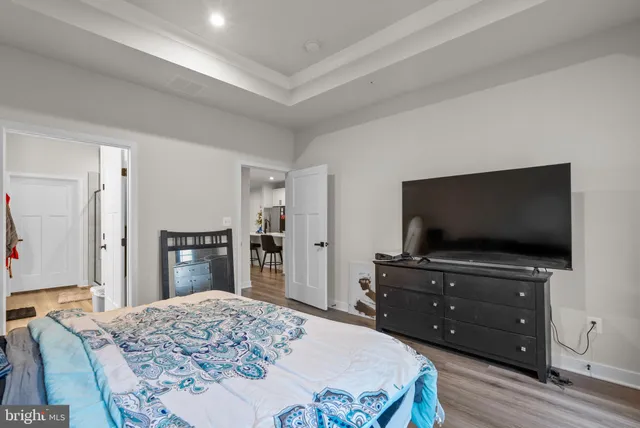 a bed sitting in a bedroom next to a lamp