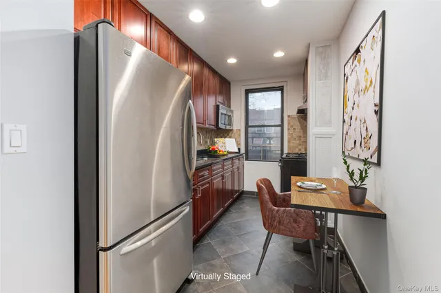 a kitchen with stainless steel appliances granite countertop a refrigerator and a stove top oven