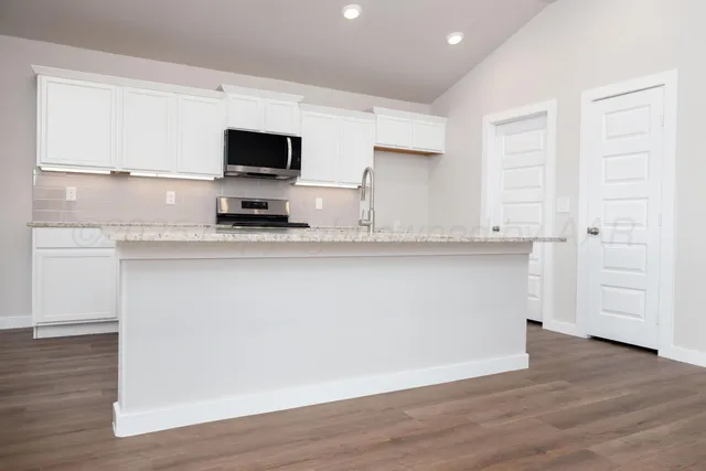 a view of cabinets with wooden floor and window