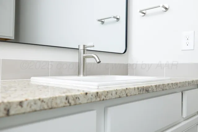 a close view of a sink and a vanity in the bathroom