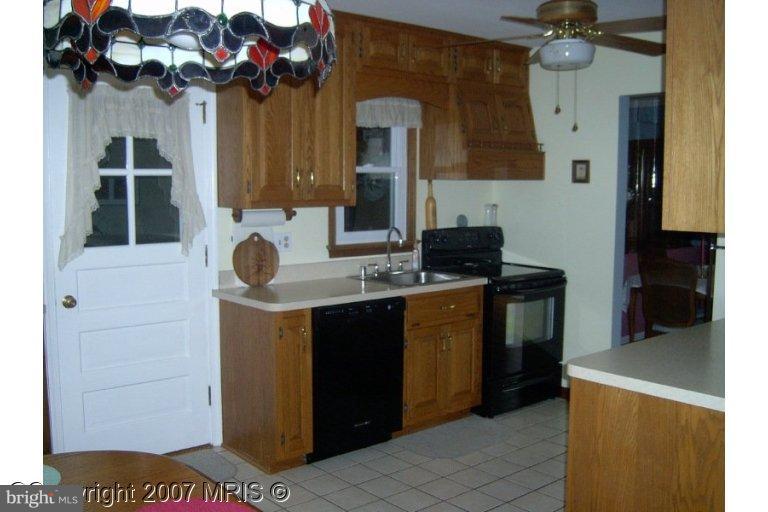 a kitchen with a sink cabinets and a wooden floor