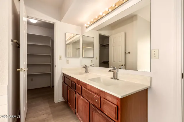 an empty room with a ceiling fan and wooden floor