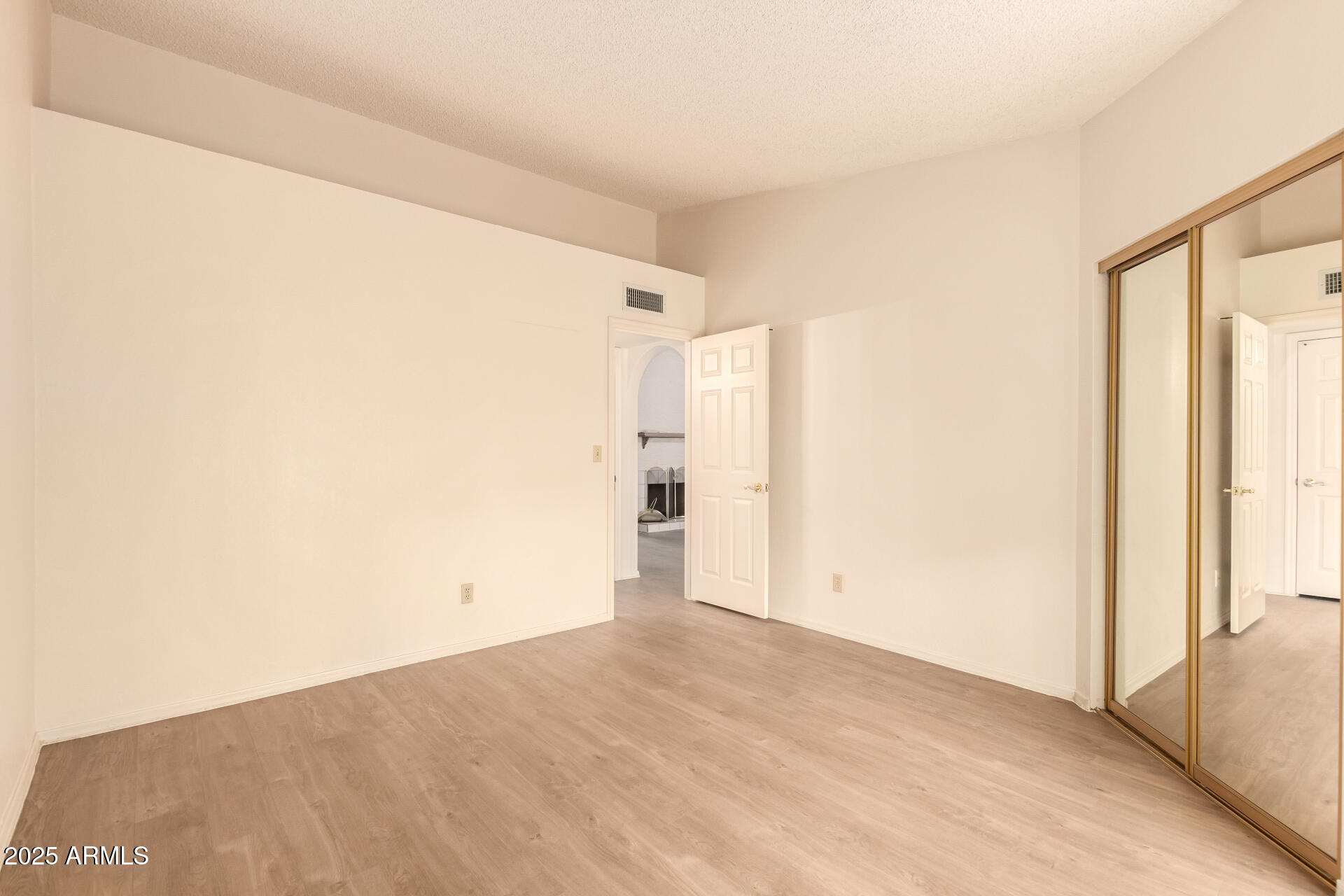 2059 East Brown Road, Unit 30 Mesa, AZ 85213 - Photo 14 of 24 a view of empty room with wooden floor