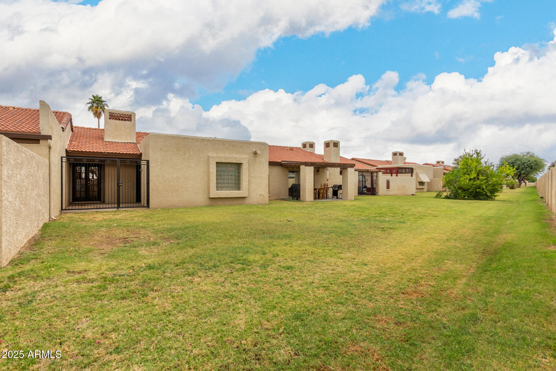 2059 East Brown Road, Unit 30 Mesa, AZ 85213 - Photo 19 of 24 a view of a house with a backyard