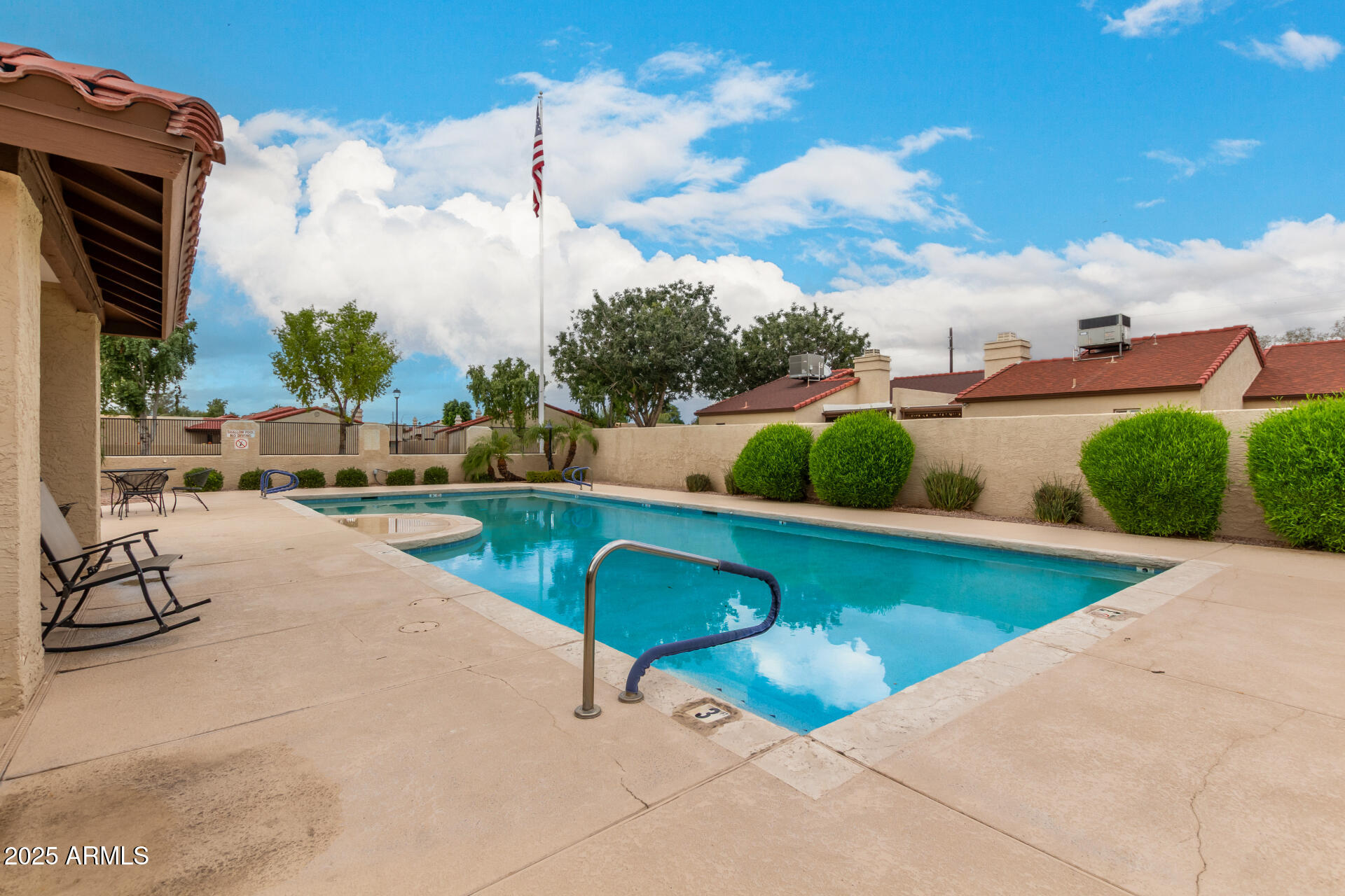 2059 East Brown Road, Unit 30 Mesa, AZ 85213 - Photo 22 of 24 a view of a swimming pool with a patio and a yard